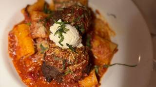 Brando’s Citi Cucina signature dishes Brando's signature meatball, Eggplant Tower, Sunday Gravy.
